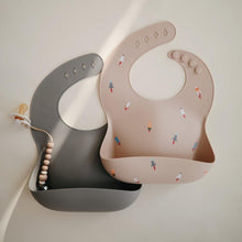 Load image into Gallery viewer, Mushie Silicone Baby Bib | Rocket