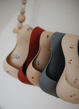 Load image into Gallery viewer, Mushie Silicone Baby Bib | Rocket