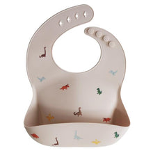 Load image into Gallery viewer, Mushie Silicone Baby Bib | Dinosaurs
