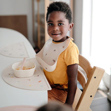 Load image into Gallery viewer, Mushie Silicone Baby Bib | Rainbow
