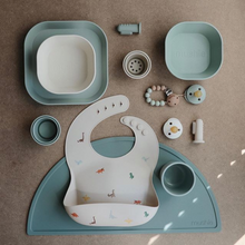 Load image into Gallery viewer, Mushie Silicone Baby Bib | Dinosaurs