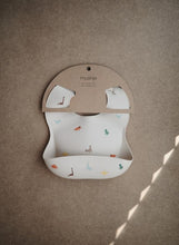 Load image into Gallery viewer, Mushie Silicone Baby Bib | Dinosaurs
